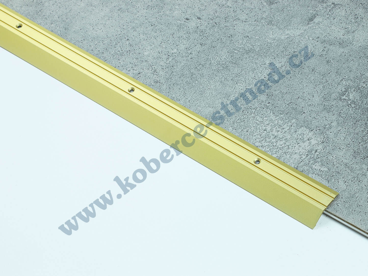 Náběh 8 mm zlatá podlahová lišta vrtaná